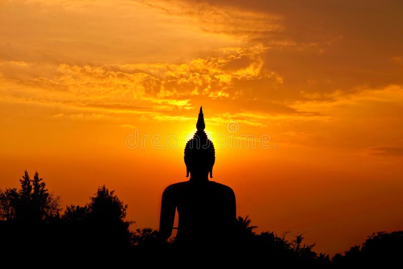 Silhouette big buddha statue against sunset