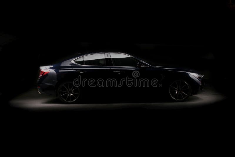 Four-door sport coupe. Silhouette of black sports car with headlights. Four-door sport coupe. Silhouette of black sports car with headlights