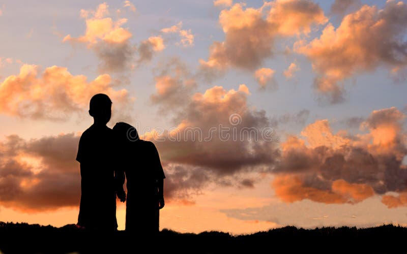 Silhouette of boy and girl stand hand in hand to watch the sunset stock photography Silhouette of boy and girl stand hand in hand to watch the sunset stock photography