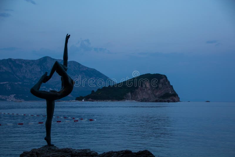 Silhouette bronze statue of a ballerina, sea view. Budva, montenegro