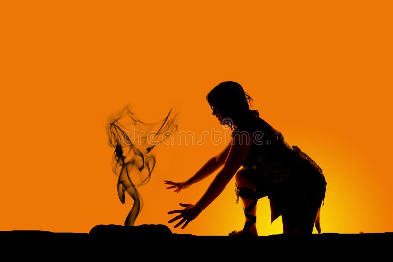 Silhouette of a cave woman kneel by fire