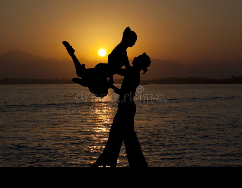 Silhouette couple in the active ballroom dance on sunset stock image