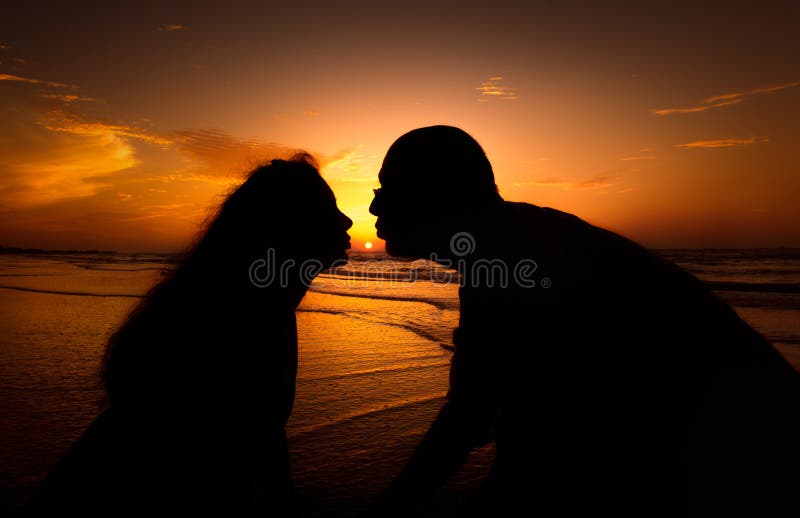 Silhouette couple kissing over sunset background royalty free stock photo Silhouette couple kissing over sunset background royalty free stock photo