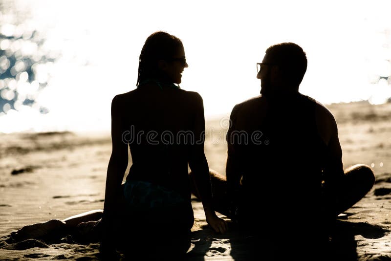 Silhouette of a couple in love on the beach at sunset.Love story.Man and a woman on the beach
