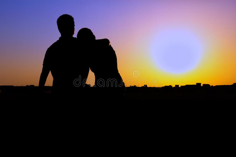 Silhouette of couple watching the sunset stock photography Silhouette of couple watching the sunset stock photography