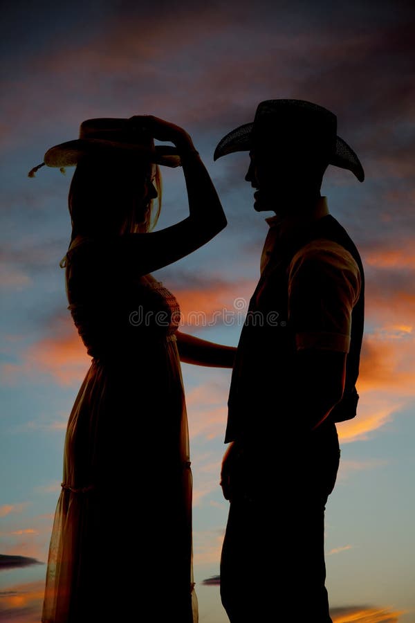Silhouette couple western hats facing stock images Silhouette couple western hats facing stock images