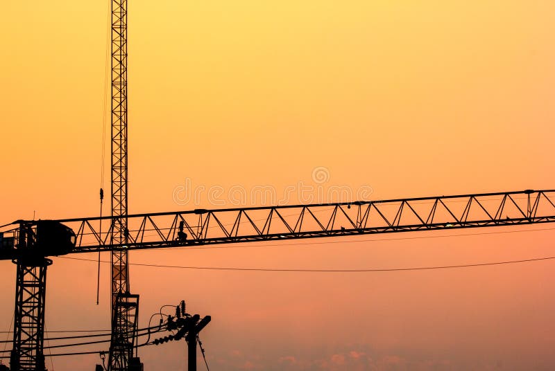 Silhouette cranes at construction side with the twilight sky royalty free stock photos