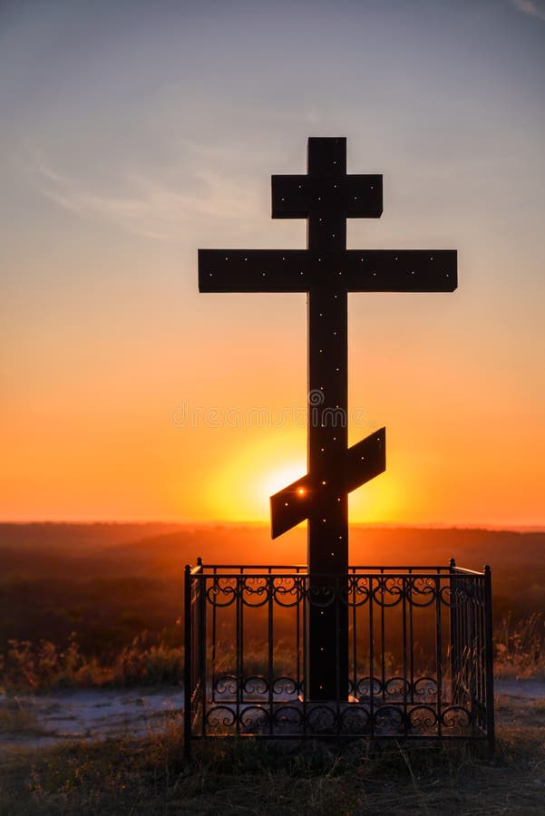 Silhouette of Cross on Mountain Sunset Background Stock Photo Image