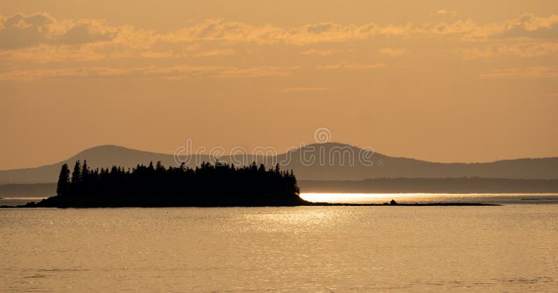 Silhouette of Crow Island in Penobscot Bay, Maine with Camden Hills in background stock photo Silhouette of Crow Island in Penobscot Bay, Maine with Camden Hills in background stock photo