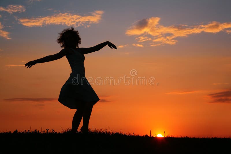 Silhouette of dancing woman on sunset royalty free stock photo
