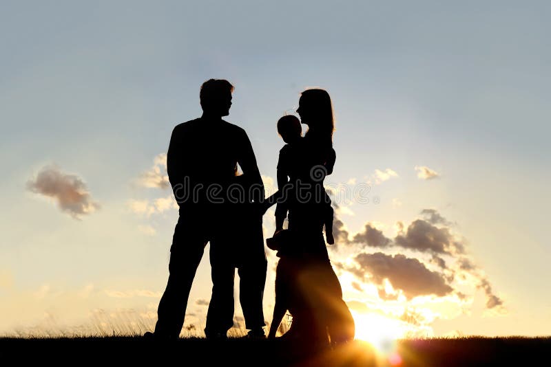 Silhouette de famille et de chien heureux dehors au coucher du soleil photographie stock libre de droits Silhouette de famille et de chien heureux dehors au coucher du soleil photographie stock libre de droits