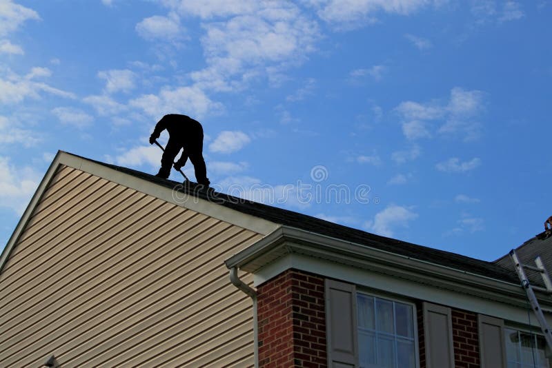 Roofer silhouette at residential house roof with beautiful cloud and blue sky, concept for home maintenance, renovation or improvement. Roofer silhouette at residential house roof with beautiful cloud and blue sky, concept for home maintenance, renovation or improvement.