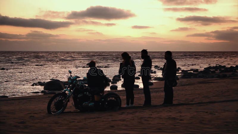 Silhouette des motards et de la moto avec le fond de lever de soleil