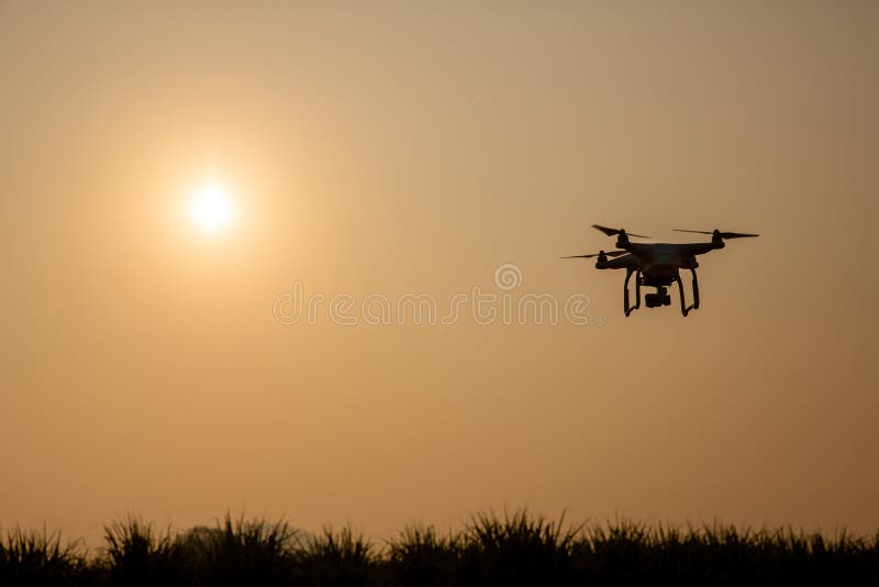 Silhouette drone against the background of the sunset. Flying drones in the evening sky. royalty free stock photo