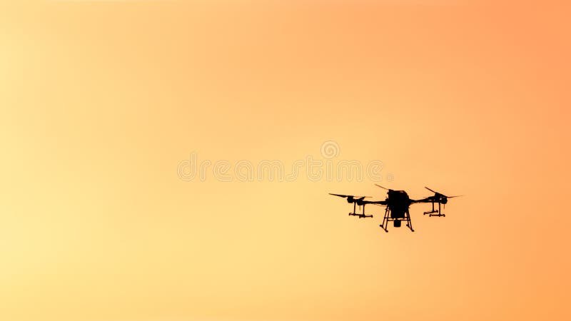 Silhouette drone flying on sunset. stock photography