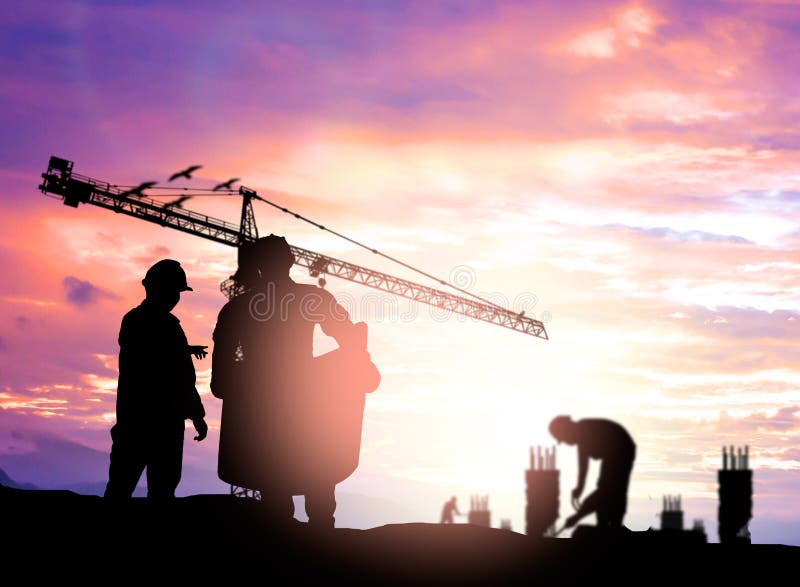 Silhouette engineer looking construction worker under tower cran in a building site over Blurred construction worker on construct royalty free stock image Silhouette engineer looking construction worker under tower cran in a building site over Blurred construction worker on construct royalty free stock image