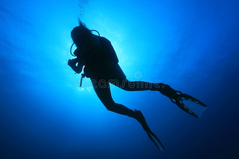Silhouette of female scuba diver stock image Silhouette of female scuba diver stock image