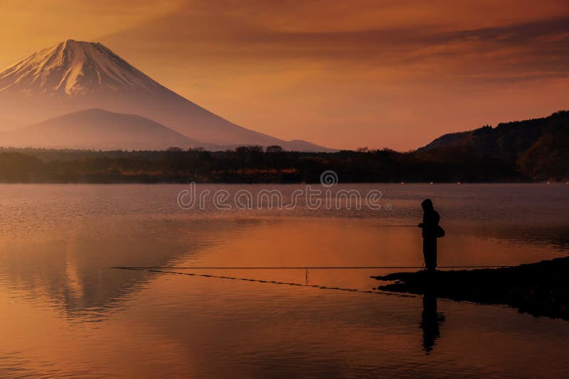 Silhouette fisherman fishing at Shoji lake with mount Fuji view reflection at dawn with twilight sky in Yamanashi stock photos Silhouette fisherman fishing at Shoji lake with mount Fuji view reflection at dawn with twilight sky in Yamanashi stock photos