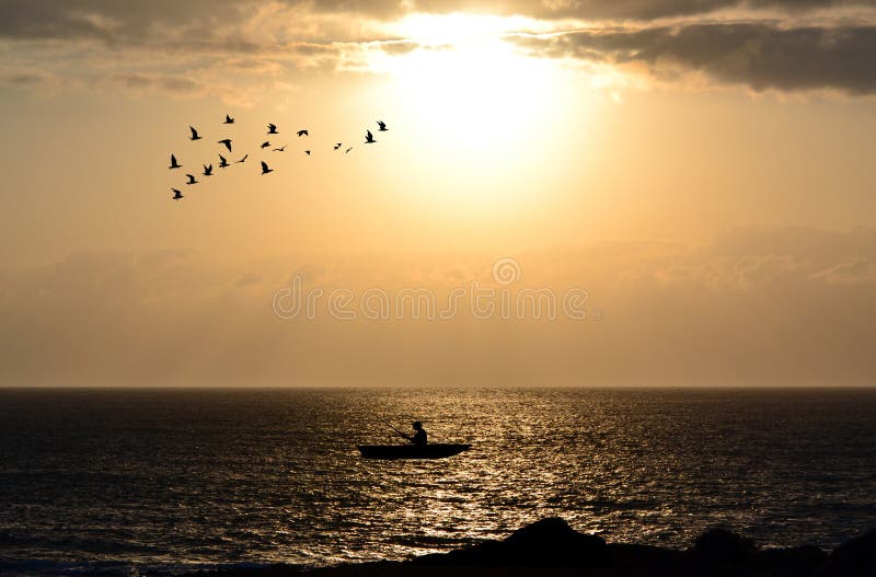 Silhouette of fishermen with his boat