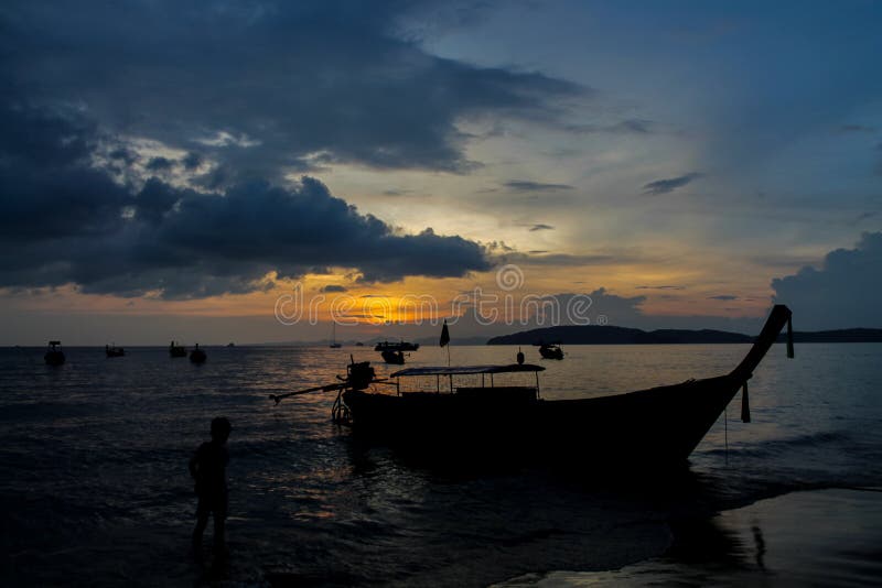 Silhouette of fishing boat at sunset on sea beach resort in Thailand, Krabi, Railey and Tonsai