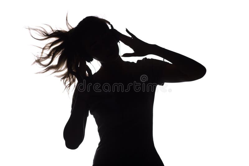 Silhouette of a girl listening to music in headphones