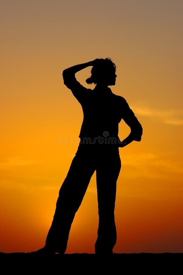 A silhouette of the proud young girl found the decision on a sunset. A silhouette of the proud young girl found the decision on a sunset