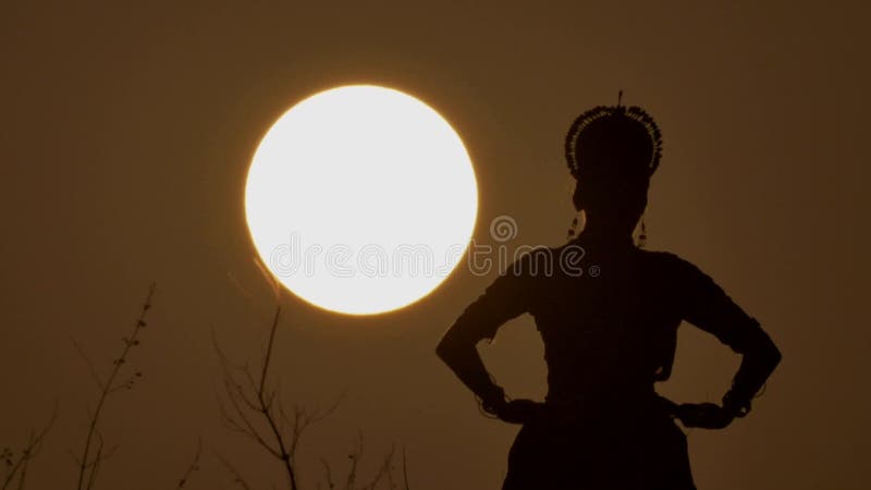 Silhouette girl oriental dancer a dance on sunset