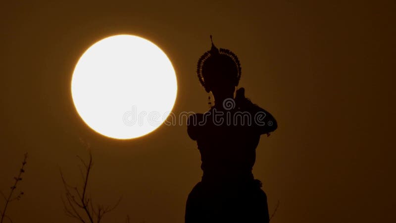 Silhouette girl oriental dancer a dance on sunset