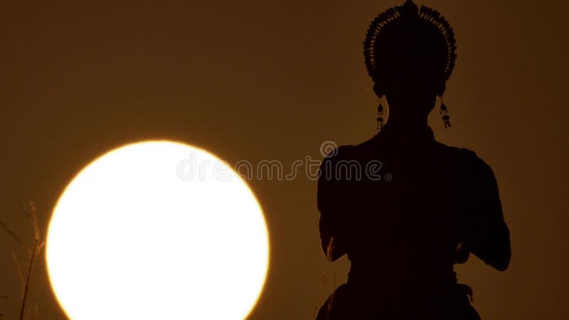 Silhouette girl oriental dancer a dance on sunset