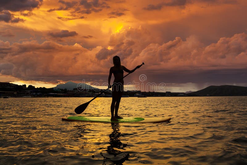 Silhouette of a girl on Stand Up Paddle Board