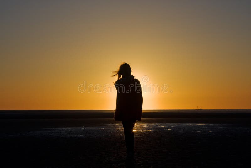 Silhouette of a girl at sunset