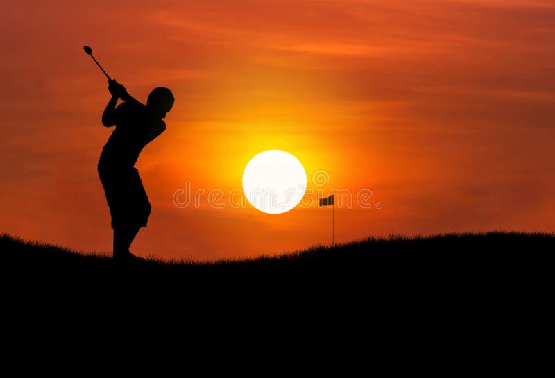 Silhouette golfer hitting golf ball at sunset