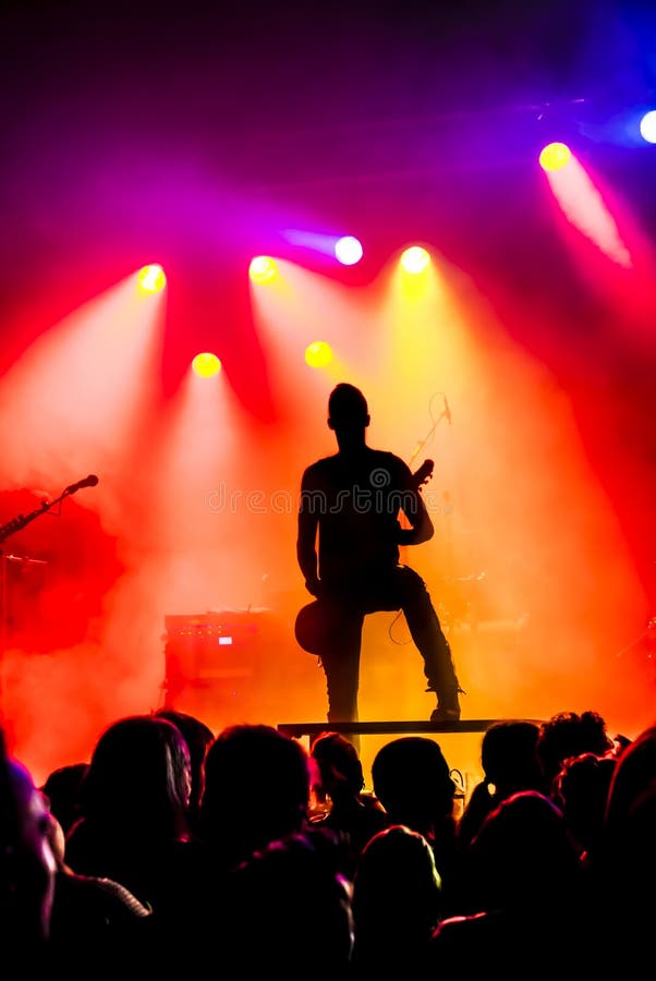Silhouette of guitar player in action on stage stock images Silhouette of guitar player in action on stage stock images