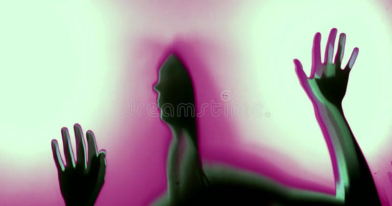 The silhouette of the hands and face, a woman in a dream psychedelic multicolored abstraction.