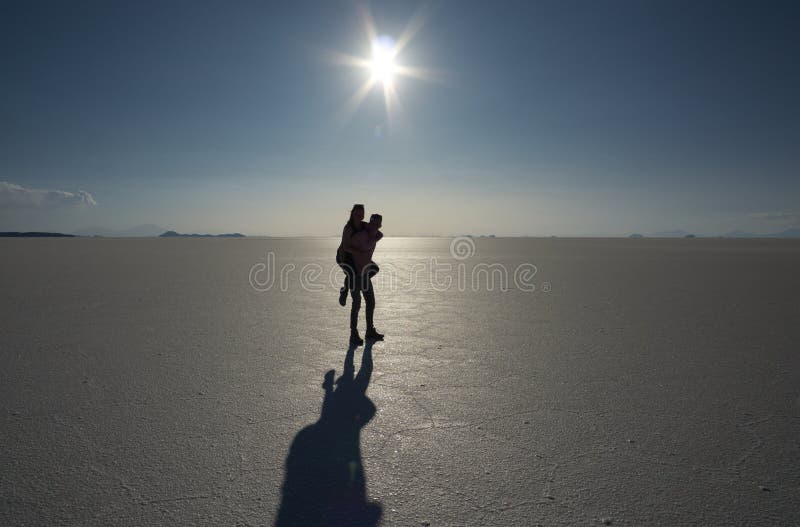 Running young couple in shadows with sun light behind them while wearing  black and grey jogging, Stock Photo, Picture And Royalty Free Image.  Pic. WE144805