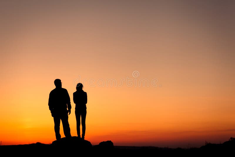 Silhouette of a happy family against the beautiful sky. Summer Sunset. Landscape