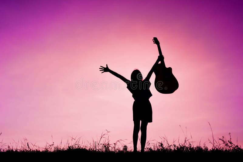 Silhouette happy girl playing guitar at the sky sunset, happy ti