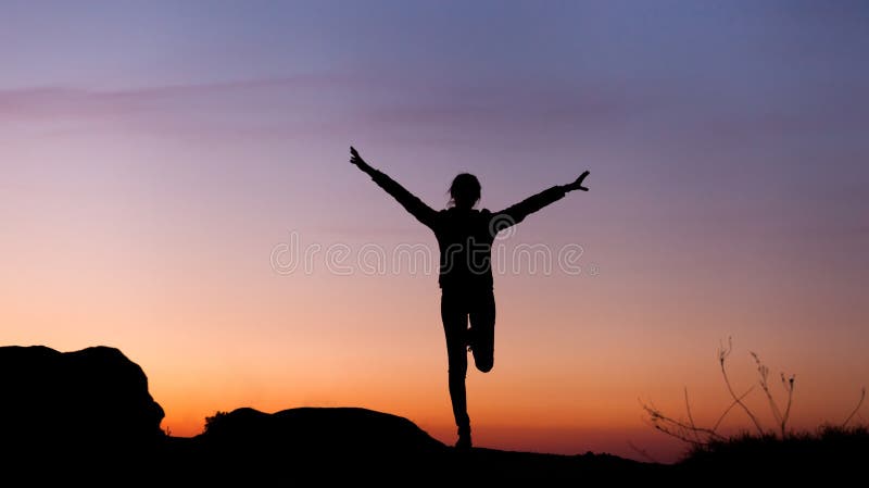 Silhouette of happy young woman with arms raised up against beautiful colorful sky. Summer Sunset. Landscape. Silhouette of happy young woman with arms raised up against beautiful colorful sky. Summer Sunset. Landscape