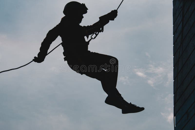 Adventure Silhouette man High angle view of rappelling. Female climbing high risk building stock images, royalty-free photos and pictures