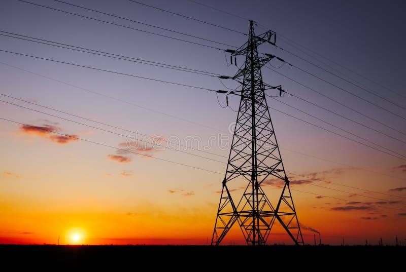 Silhouette High voltage electric towers at sunset time. High-voltage power lines. Electricity distribution station royalty free stock images Silhouette High voltage electric towers at sunset time. High-voltage power lines. Electricity distribution station royalty free stock images