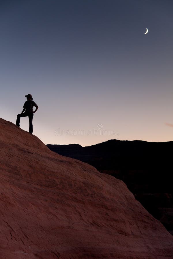 Silhouette of hiker with moon