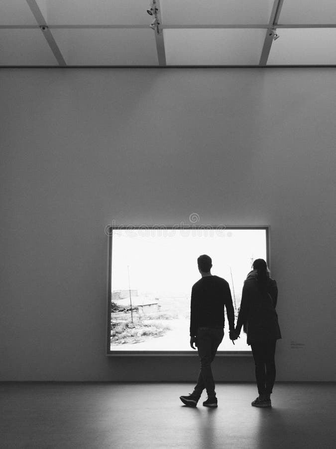 A silhouette of a male and female couple holding hands stock images A silhouette of a male and female couple holding hands stock images