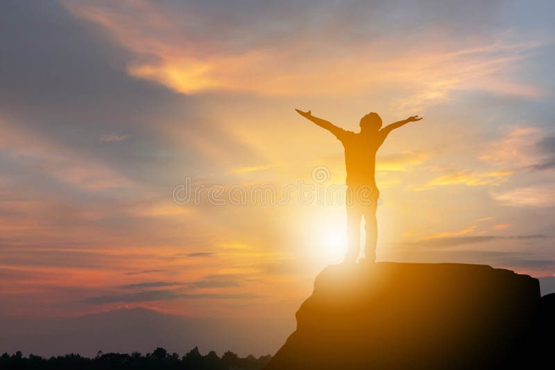 Silhouette of Man Celebration Success Happiness on a Stone Evening Sky Sunset at Beach Background, Sport and active life Concept