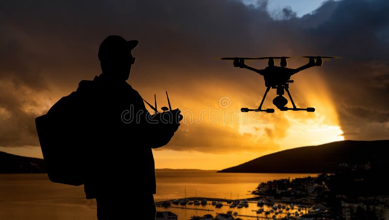 Silhouette of a man controls a drone stock photos