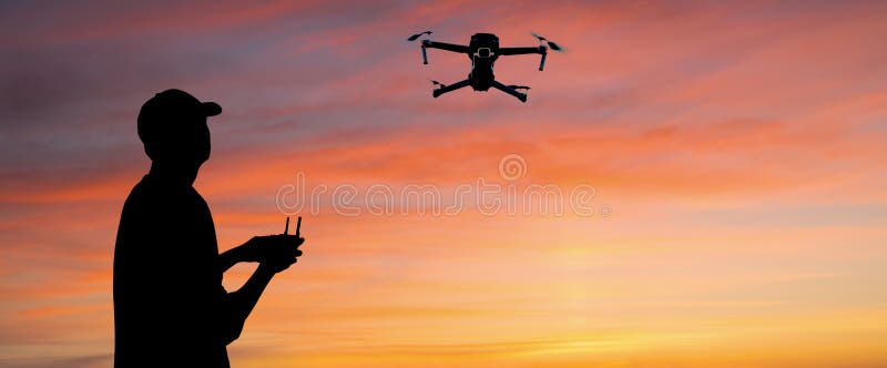 Silhouette of a man controls a drone royalty free stock photo