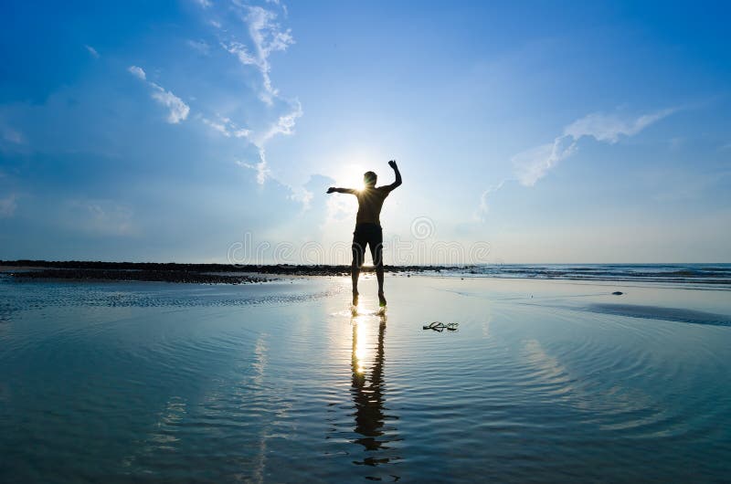 Silhouette of a man jumping over sun