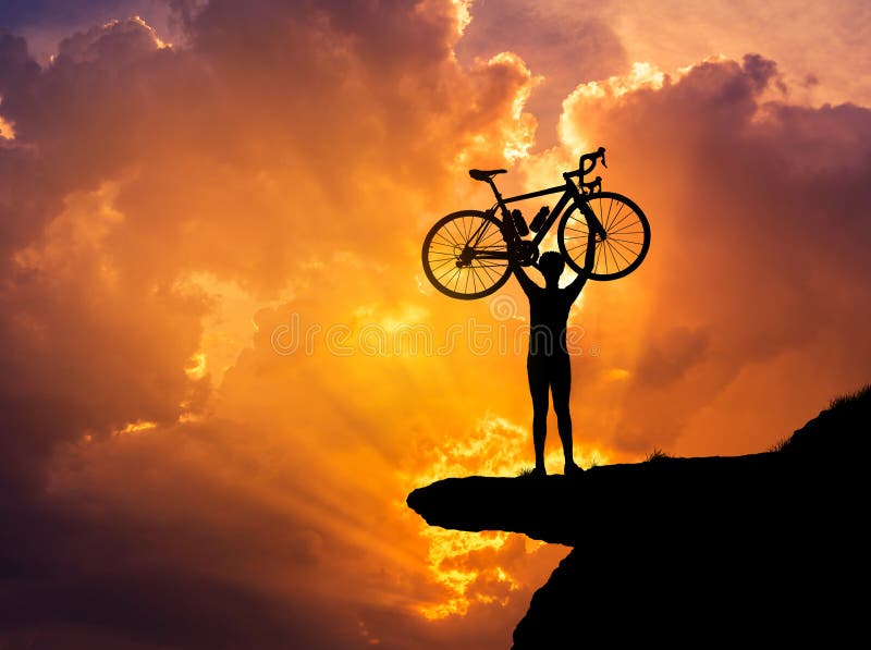 Silhouette the man lifting bicycle above his head on rock cliff mountain with sunset royalty free stock photo Silhouette the man lifting bicycle above his head on rock cliff mountain with sunset royalty free stock photo