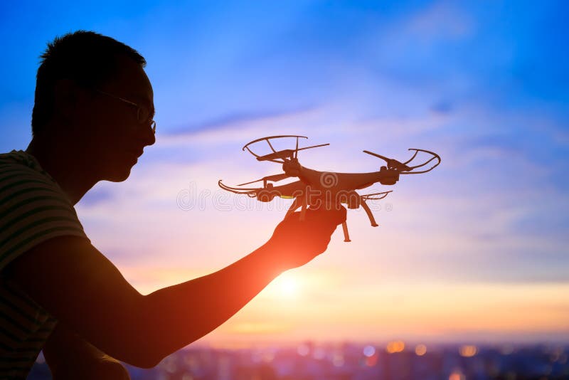 Silhouette of man take drone stock image