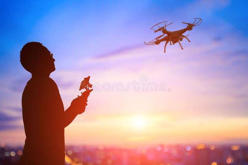 Silhouette of man take drone stock photography