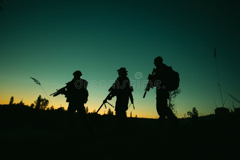 Silhouette of military soldiers with weapons at night. shot, holding gun, colorful sky. . stock images Silhouette of military soldiers with weapons at night. shot, holding gun, colorful sky. . stock images